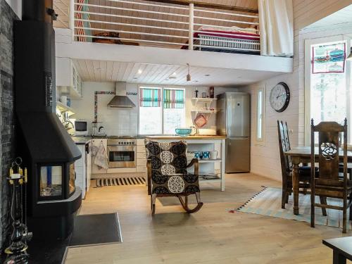 a kitchen with a living room with a table and a stove at Holiday Home Teppolan rinne by Interhome in Salla