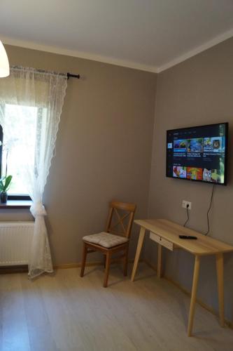 a room with a table and a chair and a window at Kuivižu Krogs - motelis in Salacgrīva