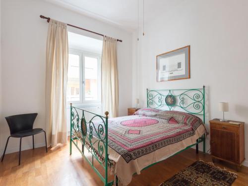 a bedroom with a bed and a chair and a window at Apartment Marco Aurelio by Interhome in Rome