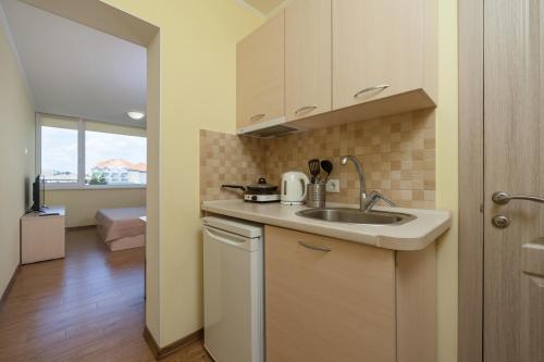 a small kitchen with a sink and a window at Hotel Promenad in Zatoka