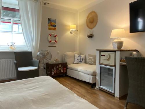 a small room with a bed and a couch at Bergland Hotel - Adults only in Salzburg