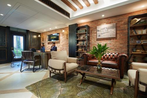 
a living room filled with furniture and a large window at The Barracks Hotel Sentosa by Far East Hospitality (SG Clean) in Singapore
