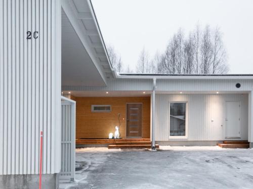 a large white building with a door on it at Luxury suites Pannunkorva C in Rovaniemi