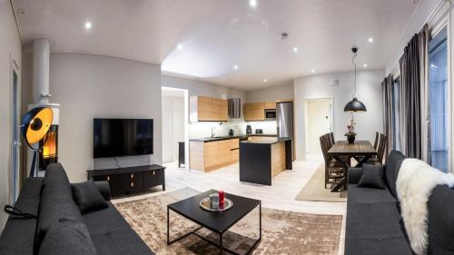 a living room with a couch and a table at Luxury suites Pannunkorva C in Rovaniemi