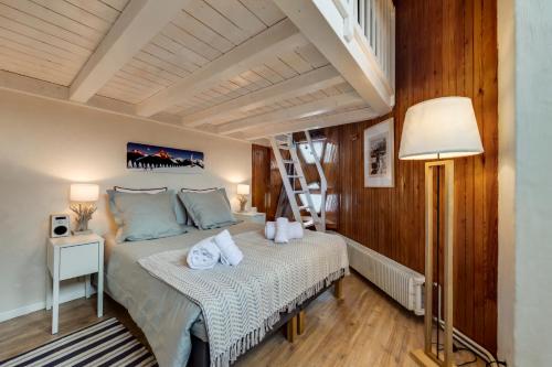 a bedroom with a bed and a ladder in it at Le Santel 199 in Val-d'Isère