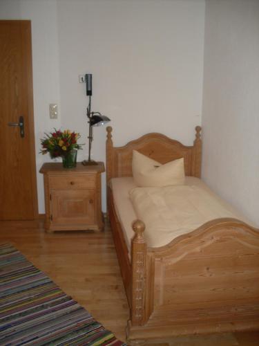 a bedroom with a wooden bed with pillows on it at Gasthof Ochsenwirt in Oberaudorf