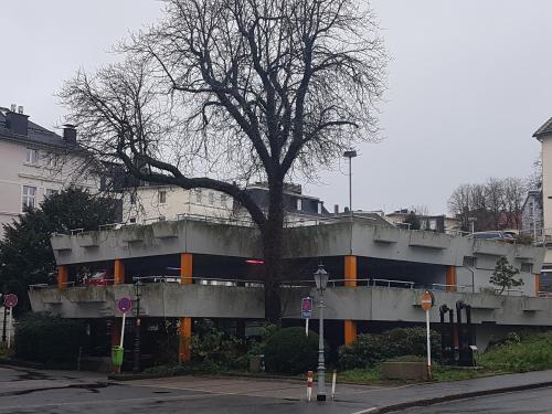 a building with a tree in front of it at Schillers Hotel & Café - GARNI - in Lüdenscheid