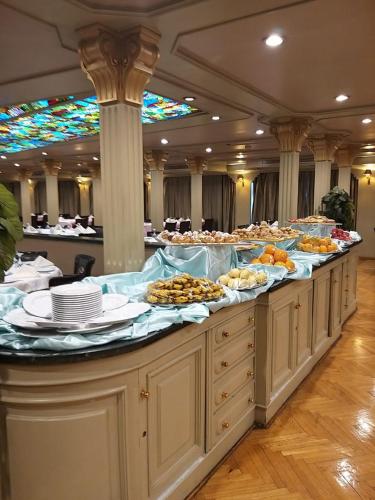 a buffet line with many plates of food on it at King Tut I Nile Cruise - Every Monday 4 Nights from Luxor - Every Friday 7 Nights from Aswan in Luxor
