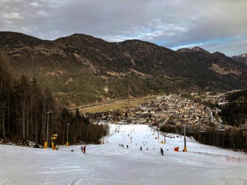 a group of people skiing down a snow covered slope at Apartments Blažič in Kranjska Gora