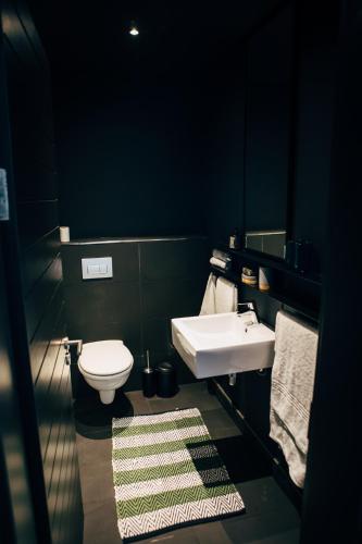 a bathroom with a sink and a toilet at Wex 1 Apartments in Cape Town