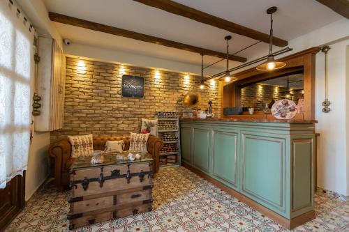 a kitchen with a bar and a table in a room at MARIA'S BOUTIQUE Rooms in Kórinthos