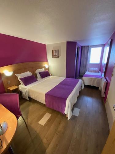 a hotel room with two beds and a window at Hôtel De La Plage in Calais