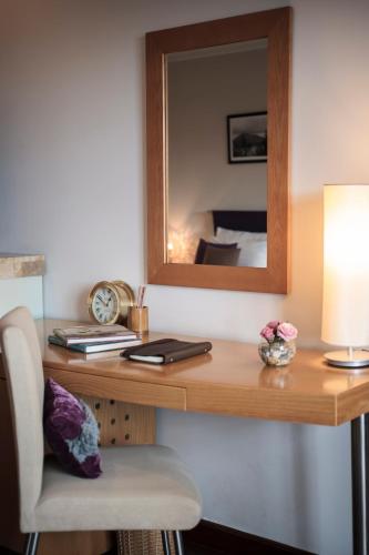 a room with a desk with a mirror and a chair at TTC Hotel - Ngoc Lan in Da Lat