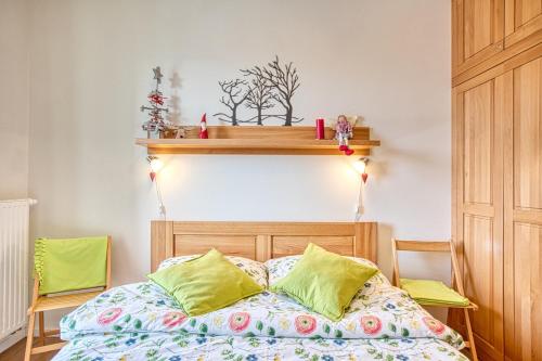 a bedroom with a bed with green pillows at KUBO TATRY - Starý Smokovec in Smokovce
