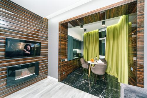 a bathroom with a fireplace and a sink and a television at Luxury Apartments Arena Guliver in Kyiv