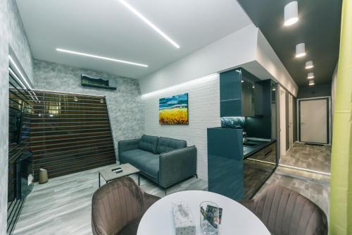 a living room with a couch and a table at Luxury Apartments Arena Guliver in Kyiv