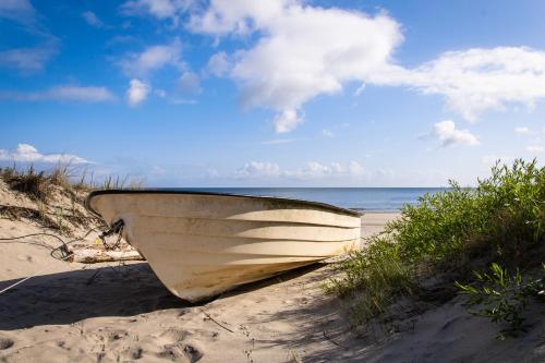 a boat sitting on the sand on the beach at Hotel am Fischerstrand in Bansin