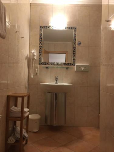a bathroom with a sink and a mirror at Hotel Zum Granitzl in Mariapfarr