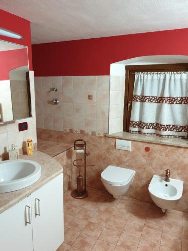 a bathroom with a white toilet and a sink at Casa MAEL - CIR 0017 in Saint-Pierre