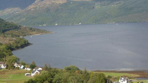 a view of a large lake with houses and trees at Rowan House B&B Rooms & A Self Catering Apartment in Lochgoilhead