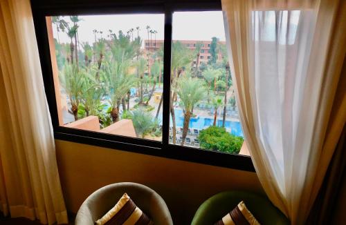 a window with a view of a resort at Kenzi Rose Garden in Marrakech