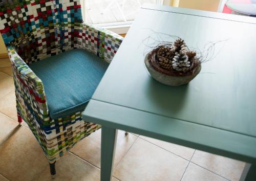 a table and a chair with a plant on it at Berghaus Freiburg - Appartement Hotel auf dem Schauinsland in Oberried