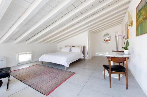 1 dormitorio con 1 cama, mesa y sillas en San Clemente, en Crema