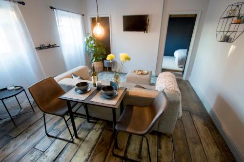 a living room with a table and a couch at Spirit of Prince Street Hull Old Town in Hull