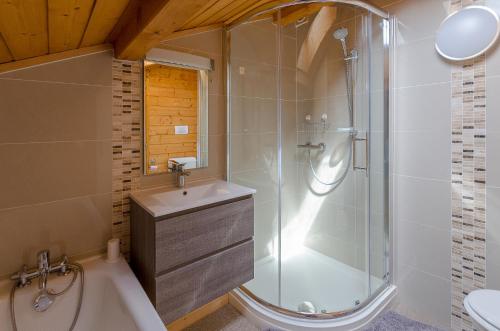 une salle de bain avec douche et lavabo dans l'établissement Chalet de Vantaa, aux Gets