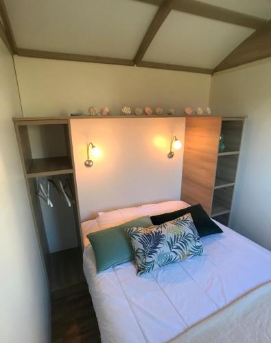 a bedroom with a bed with two pillows on it at la ferme des epis in Ouffières