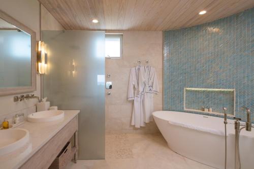 a bathroom with two sinks and a bath tub at Curtain Bluff - All Inclusive in Old Road
