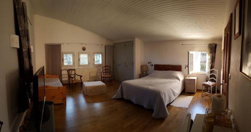 a bedroom with a bed in the middle of a room at Mas du Kairos in Venasque