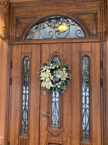 a wooden door with a wreath on it at Сонячна Соната in Polyana