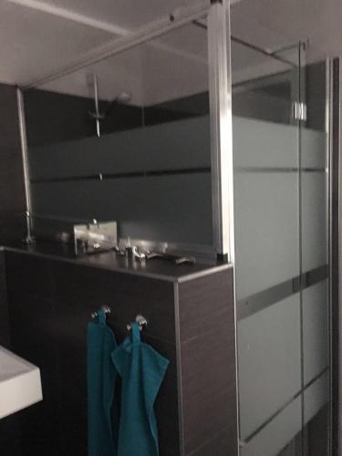 a bathroom with a mirror and a sink with blue towels at Villa Waidhof in Schierke