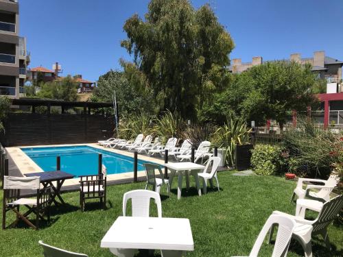 a group of chairs and tables next to a pool at Hotel Europa in Ostende