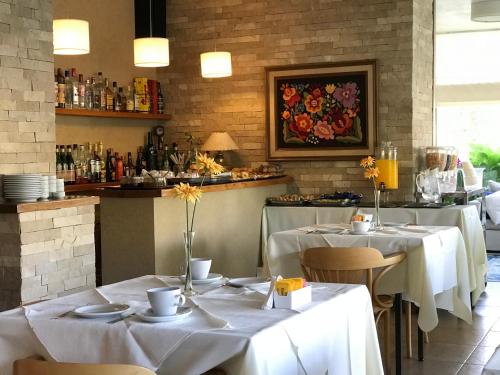 a restaurant with two tables with white tablecloths at Hotel Europa in Ostende
