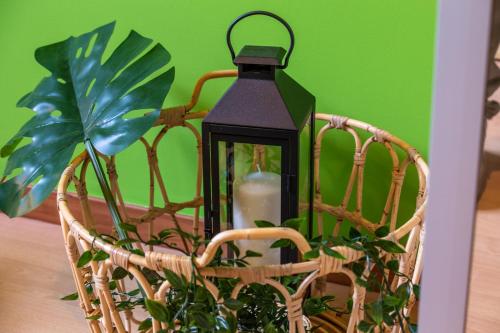 a lantern sitting in a basket with a plant at Juliette Rooms in Iesi