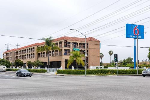 a building on the corner of a street with cars at Motel 6-Gardena, CA - South in Gardena