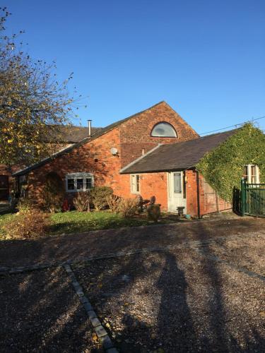 a brick house with a driveway in front of it at The Barn Bed and Breakfast in Liverpool