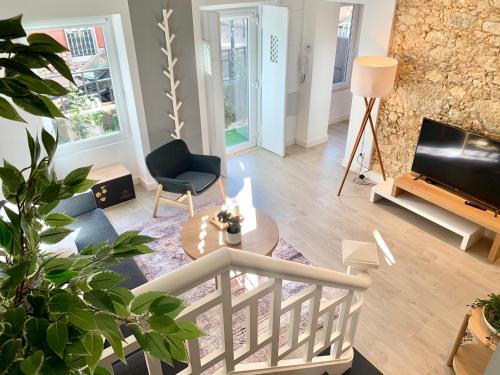 a living room with a table and a tv at Home Out City Villa in Lisbon