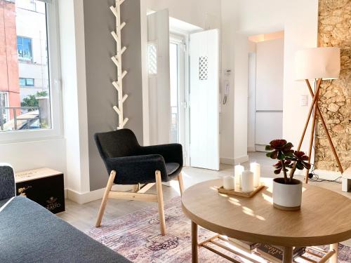 a living room with a table and a chair at Home Out City Villa in Lisbon