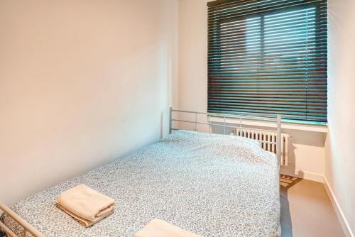 a bedroom with a bed and a window at Spacious Apartments in the Heart of Antwerp in Antwerp
