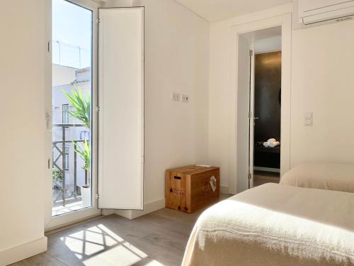 a bedroom with a bed and a large window at Home Out City Villa in Lisbon