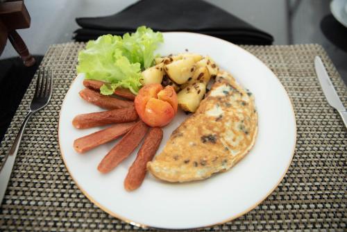 a white plate of food with carrots and vegetables at White Castle in Wadduwa