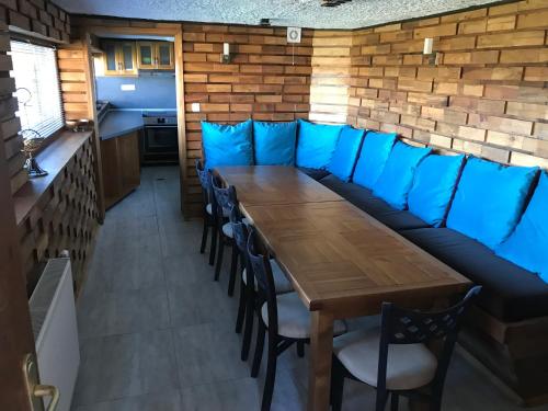 a dining room with a wooden table and chairs at RELAX Guest House in Tsigov Chark