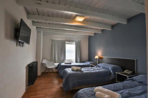 En eller flere senge i et værelse på Hotel Bariloche Mountain