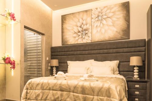 a bedroom with a large bed with a black headboard at Villa Domina in Split