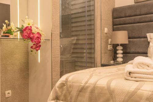a bedroom with a bed with a vase of flowers at Villa Domina in Split