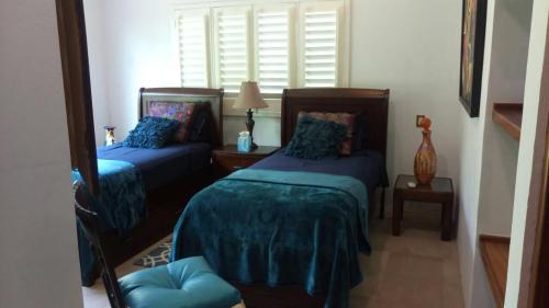La Union de Isidoro Montes de OcaにあるLoft on the Pacificのベッドルーム(青い掛け布団付きのベッド2台付)