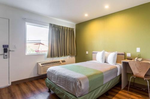 a hotel room with a bed and a window at Motel 6-Needles, CA in Needles